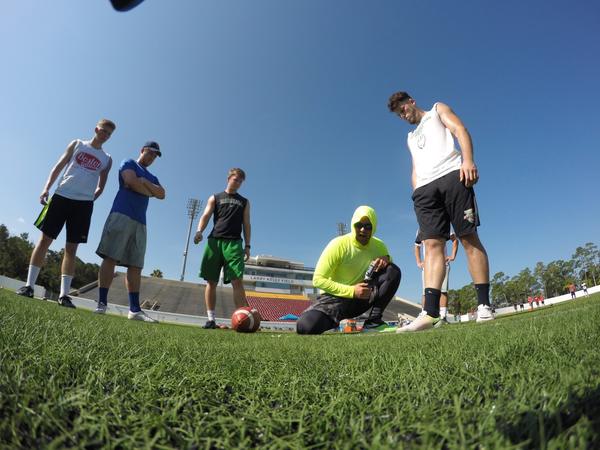 Coach Dan Lundy and Brian Egan coaching on the field